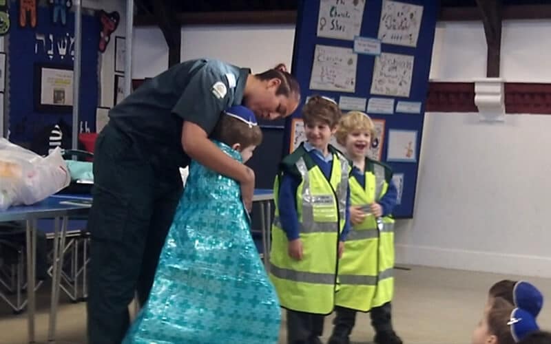 Sacks Morasha pupils enjoying the visit from a London Ambulance Service paramedic