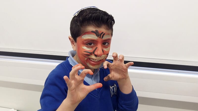 A Sacks Morasha pupil trying out face paint